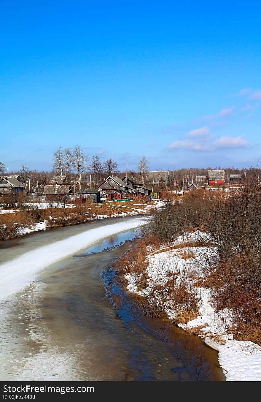 Village on spring coast river