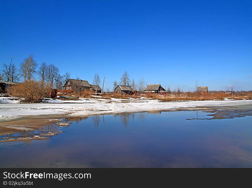 Village on spring coast river