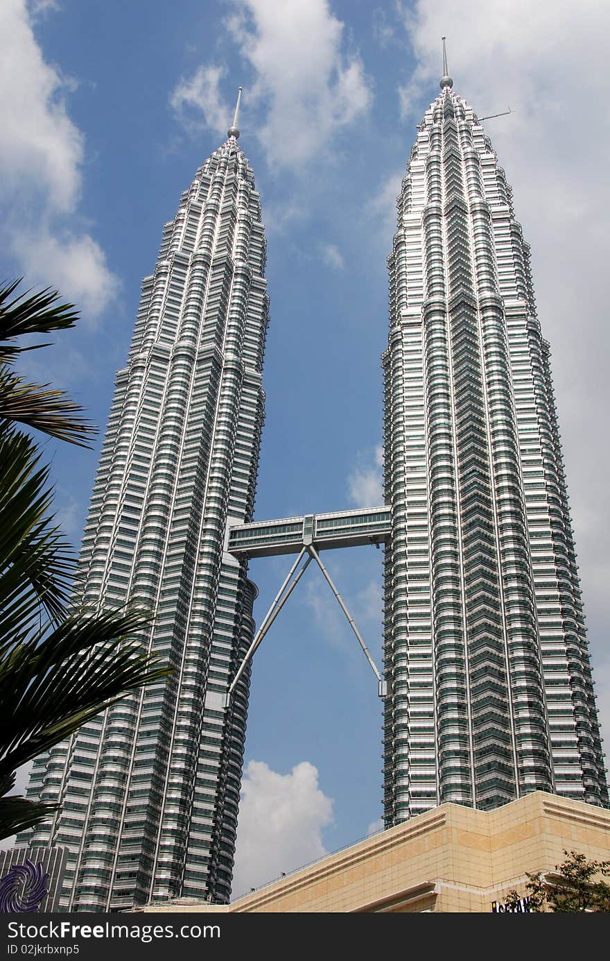 The dramatic 1,482 foot high twin Petronas Towers, connected by the 40th floor Sky Bridge, soar into the sky high above the city of Kuala Lumpur, Malaysia. The dramatic 1,482 foot high twin Petronas Towers, connected by the 40th floor Sky Bridge, soar into the sky high above the city of Kuala Lumpur, Malaysia.