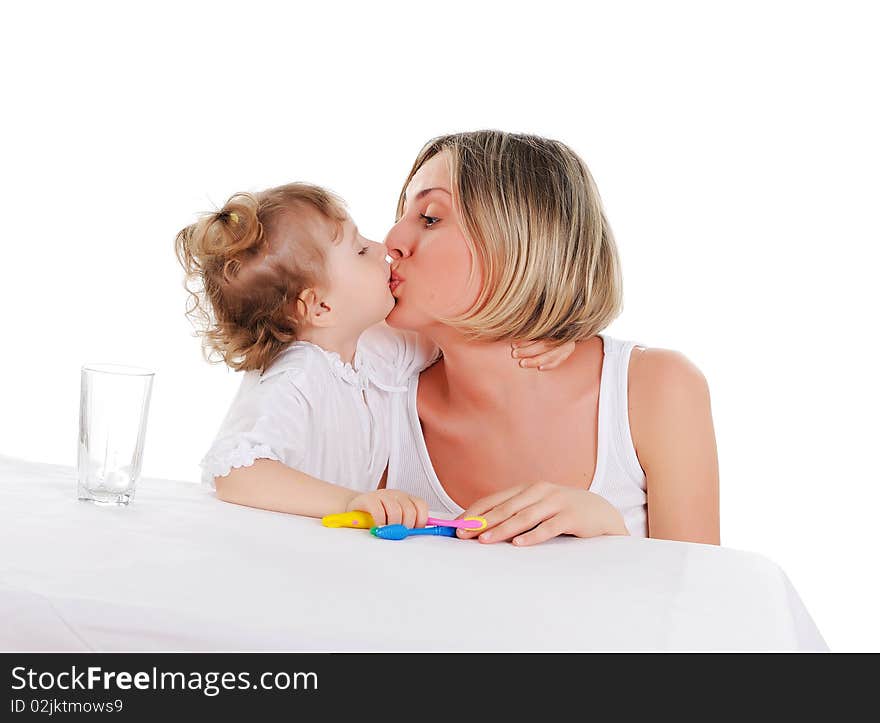 Young mother and her young daughter hugged and kissed each other on a white background