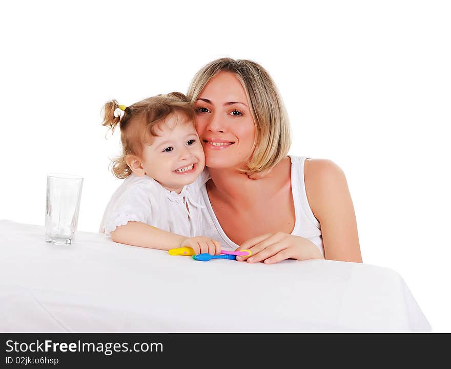 Young mother and her young daughter hugged and kissed each other on a white background