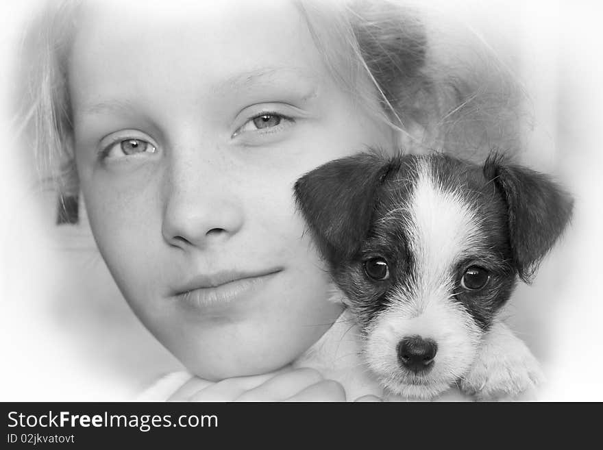 Beautiful young girl smiling and holding her puppy. Beautiful young girl smiling and holding her puppy