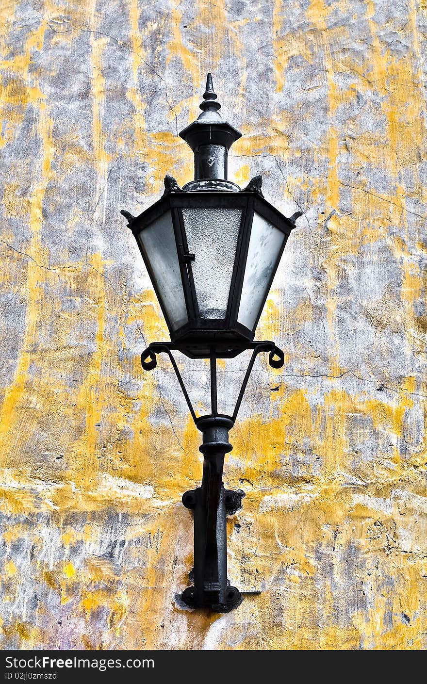 Old lantern on yellow wall in street of Tallin old town, Estonia. Old lantern on yellow wall in street of Tallin old town, Estonia