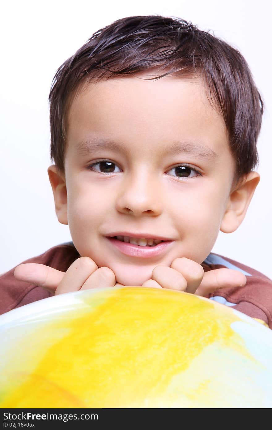 Child smiling and looking at the camera with a ball. Child smiling and looking at the camera with a ball