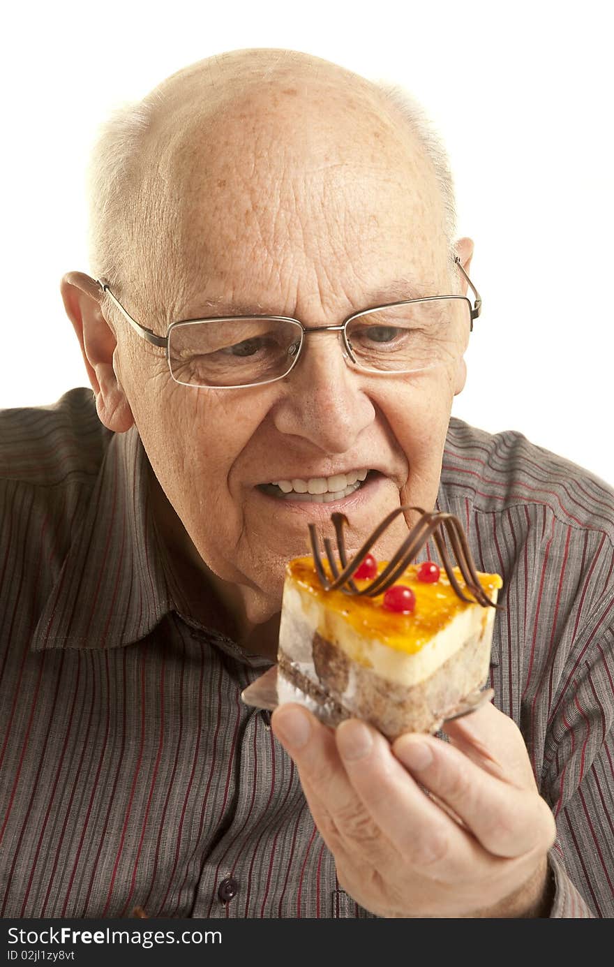 Senior Man Eating A Cake