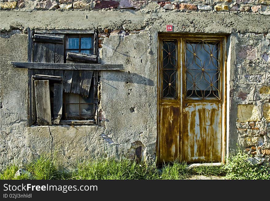 An abandoned building with a window and door. An abandoned building with a window and door