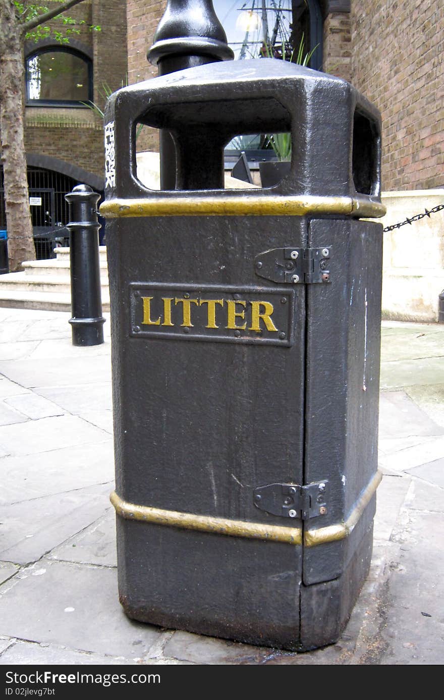 Black garbage can on a city background. Black garbage can on a city background