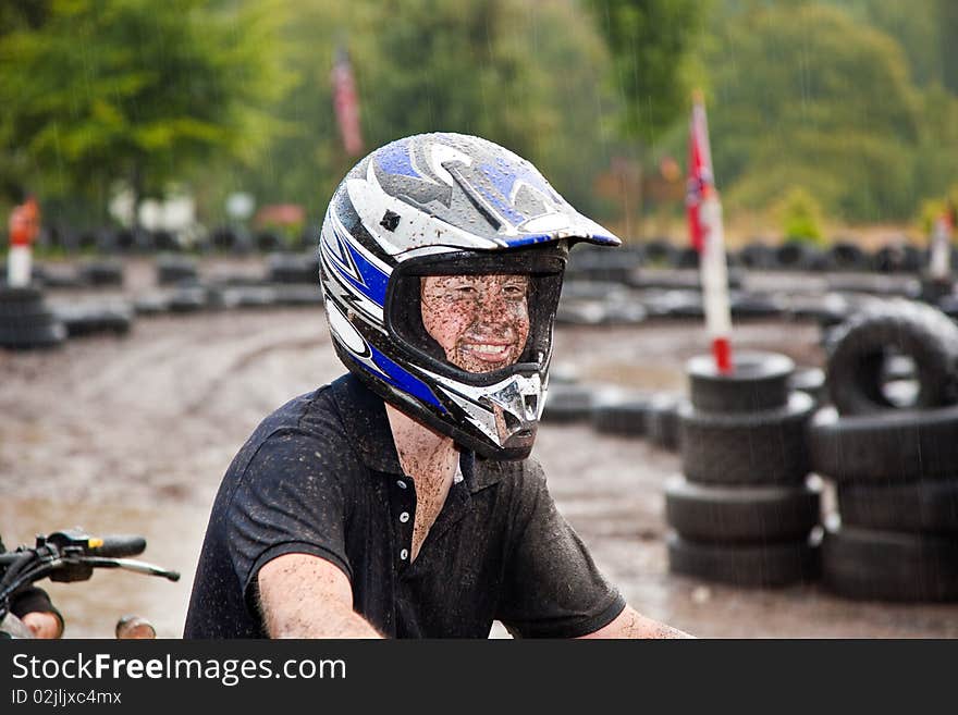 Young boy is faszinated by quad driving and enjoyes is, his face is dirty from mud. Young boy is faszinated by quad driving and enjoyes is, his face is dirty from mud