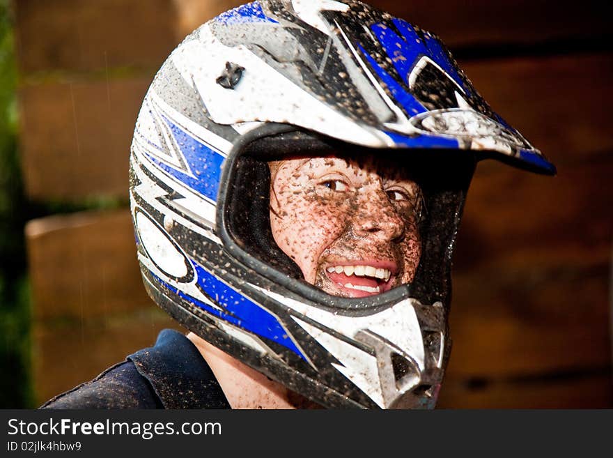 Young boy is faszinated by quad driving and enjoyes is, his face is dirty from mud. Young boy is faszinated by quad driving and enjoyes is, his face is dirty from mud