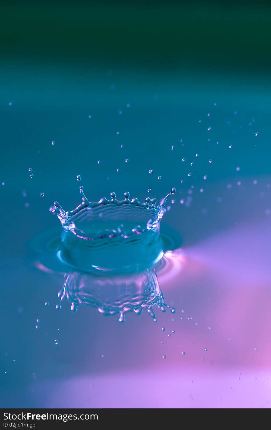 Water drop hitting a water surface making a splash. Water drop hitting a water surface making a splash