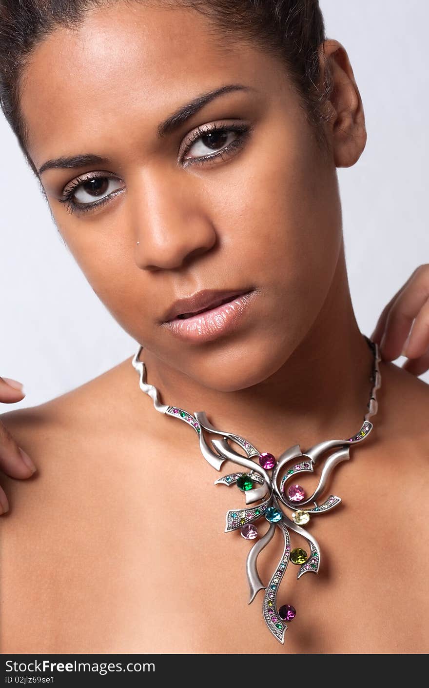 A portrait of a pretty model wearing a colorful necklace. A portrait of a pretty model wearing a colorful necklace