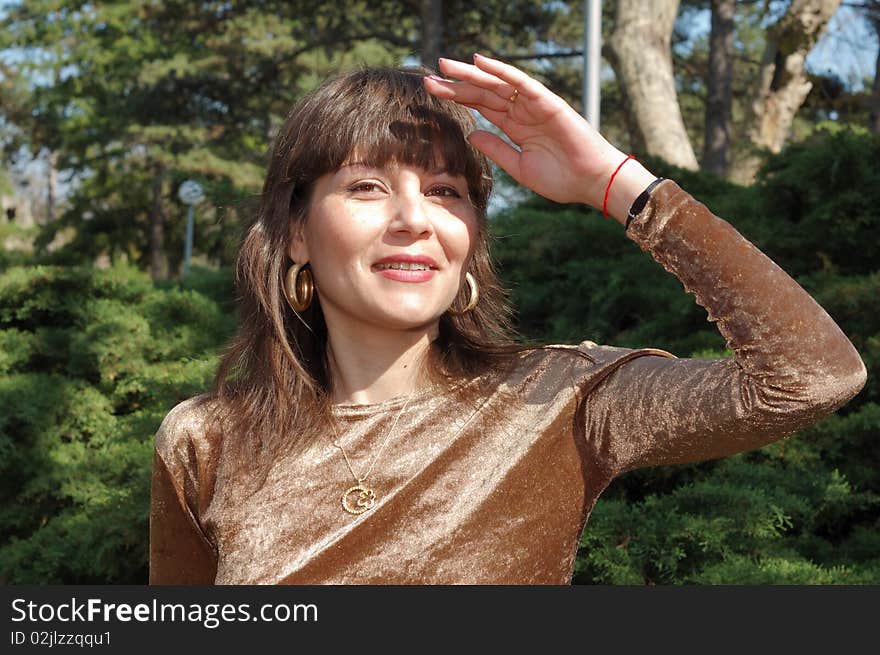 Portrait of beautiful woman in a green park. Portrait of beautiful woman in a green park