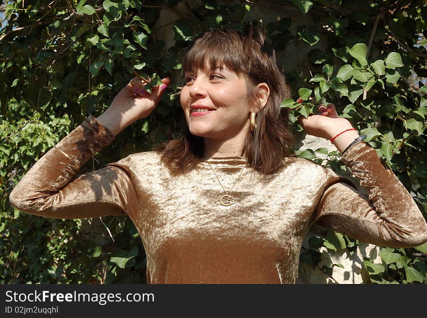 Portrait of beautiful woman in a green park. Portrait of beautiful woman in a green park