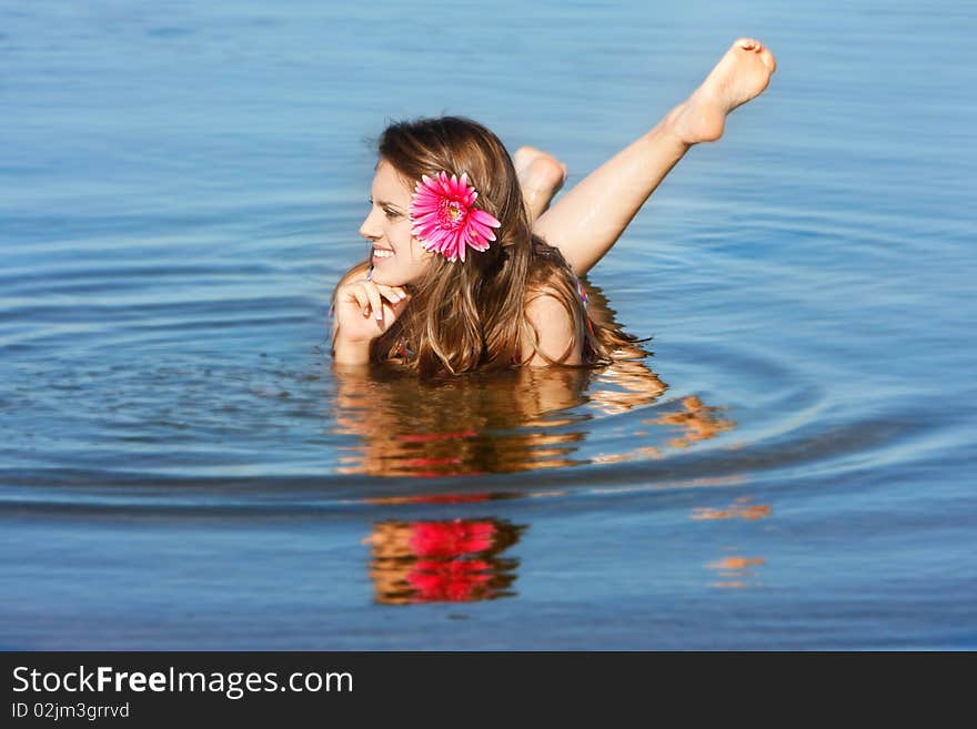 Young beautiful woman in water