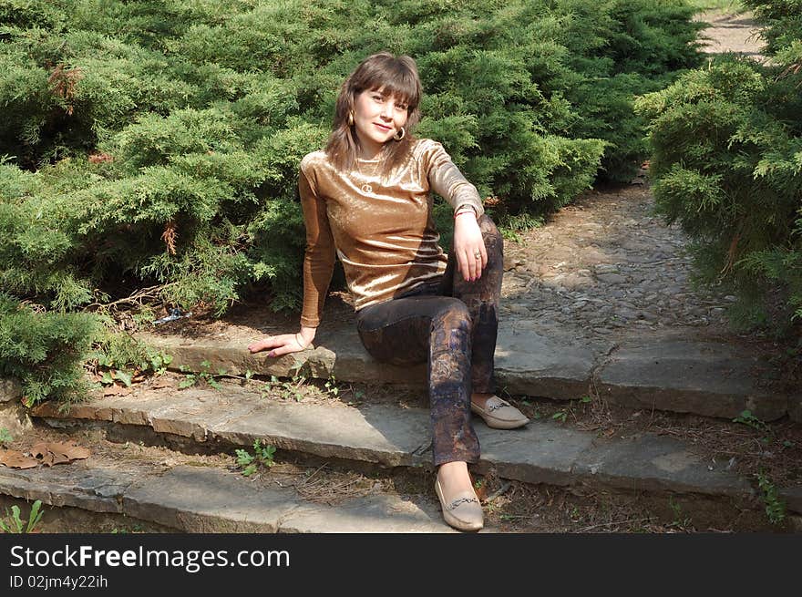 Portrait of beautiful woman in a green park. Portrait of beautiful woman in a green park