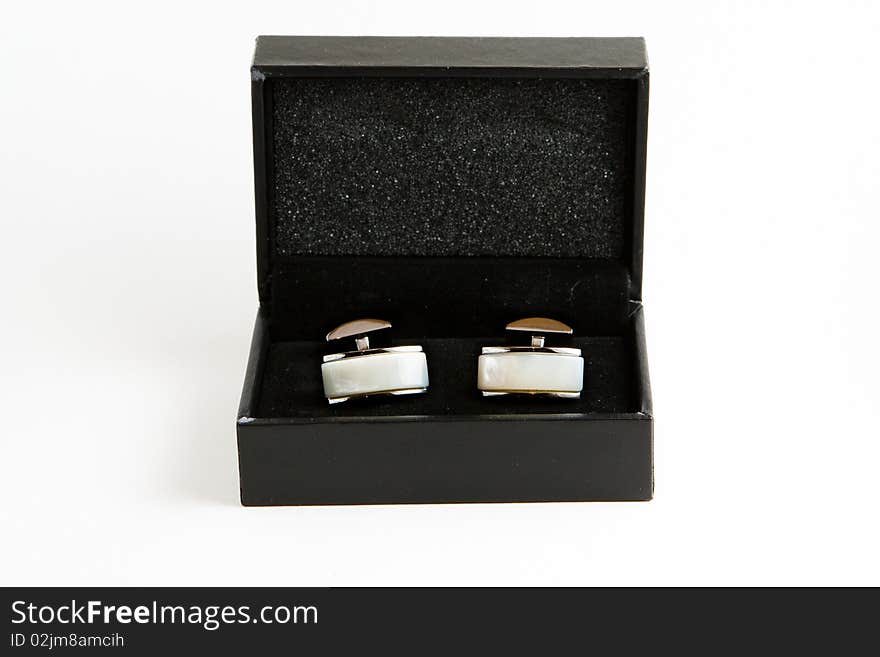 Elegant cufflinks made of metal and pearl, in a black box. Elegant cufflinks made of metal and pearl, in a black box