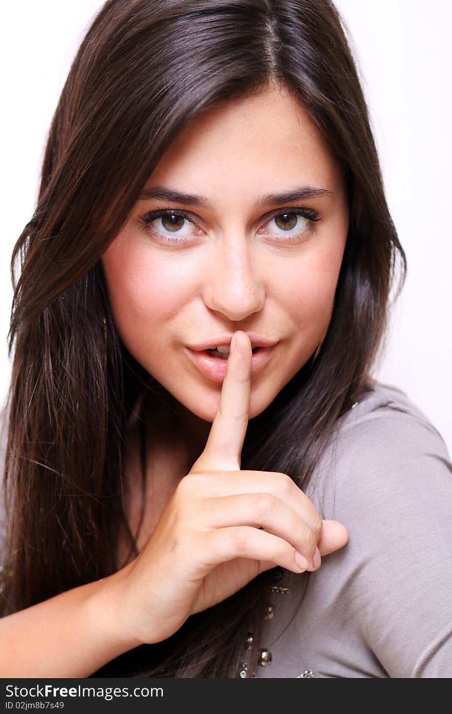 Portrait of young woman with silence sign isolated on white background. Portrait of young woman with silence sign isolated on white background