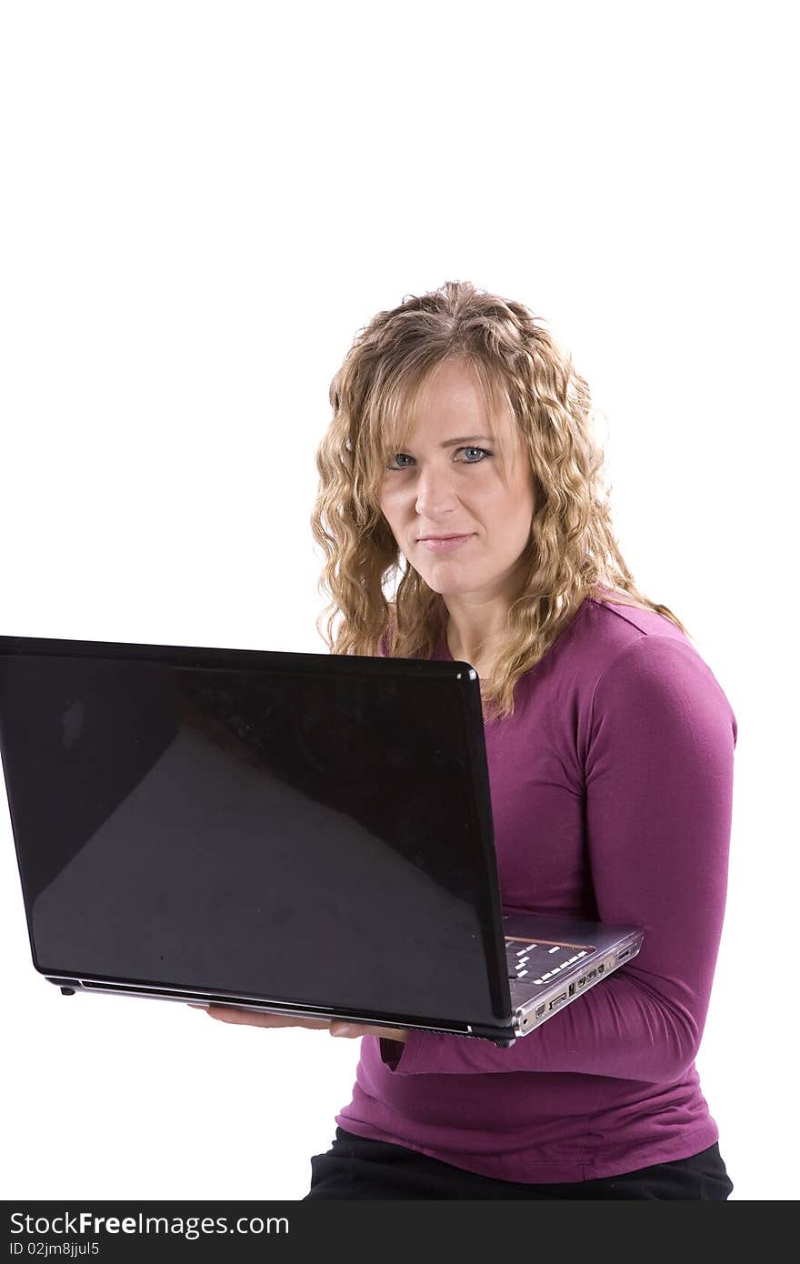 A woman with a smirk on her face holding a laptop. A woman with a smirk on her face holding a laptop.