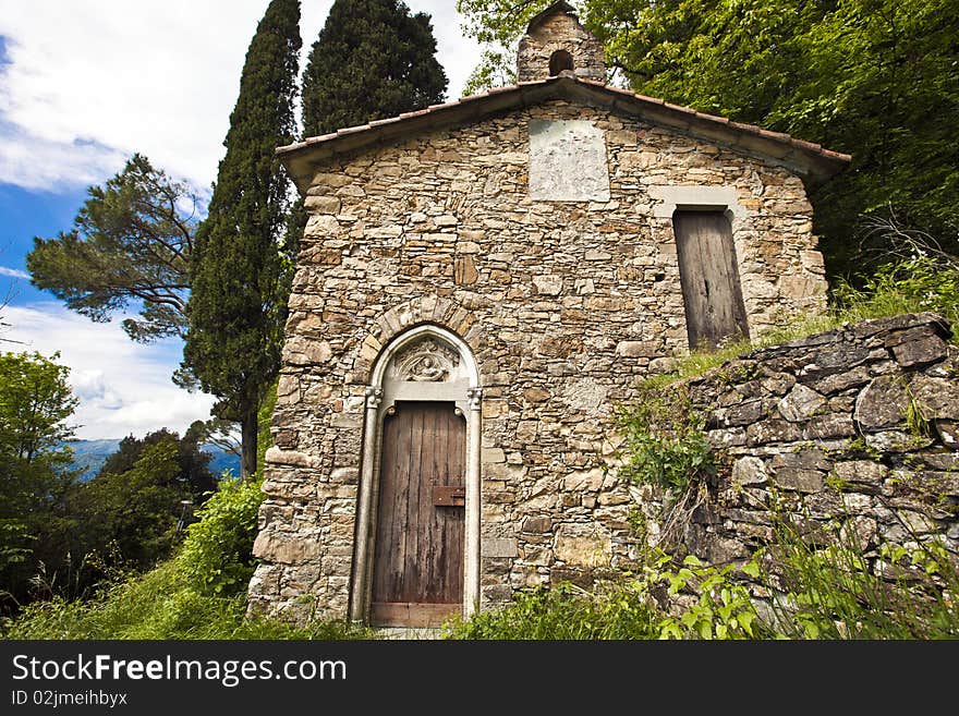 An old stone church desecrated surrounded by nature