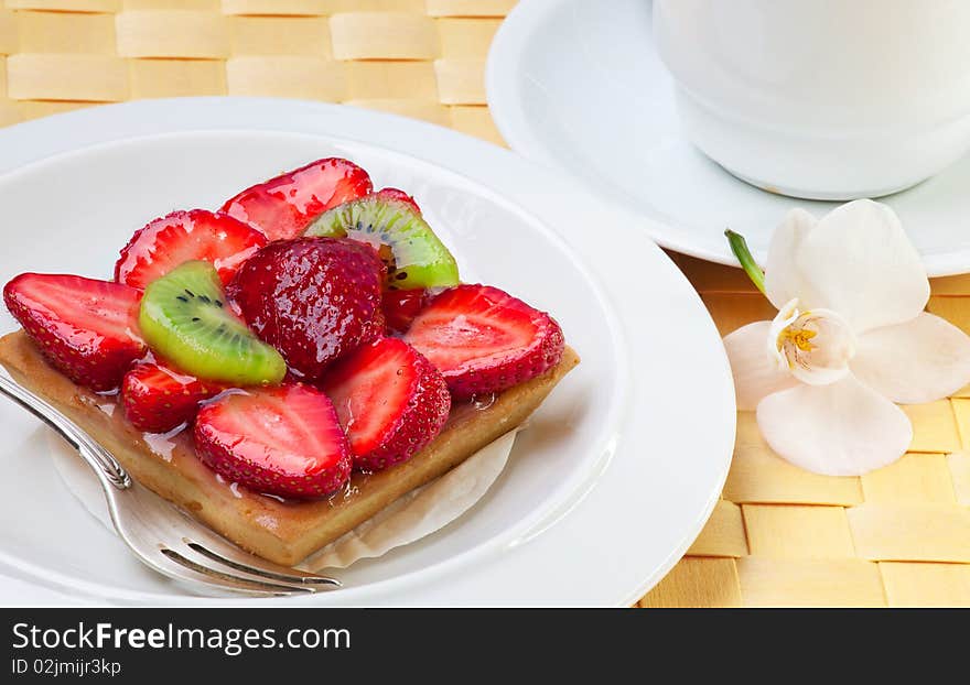 Strawberry cake with kiwi on white plate