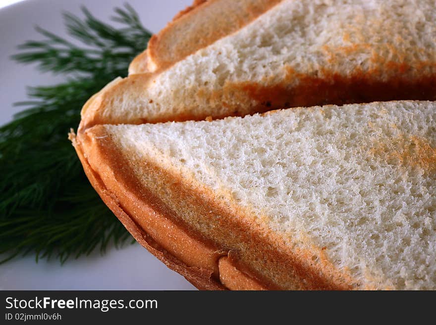 The close up of bread of which is made a sandwich in a roaster.