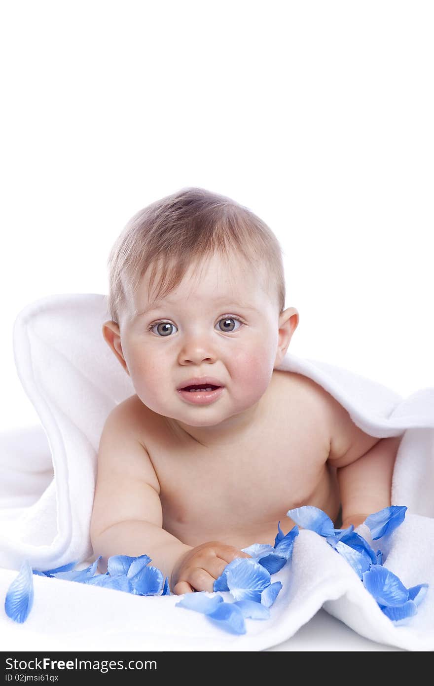 Beautiful baby under a white towel on white background