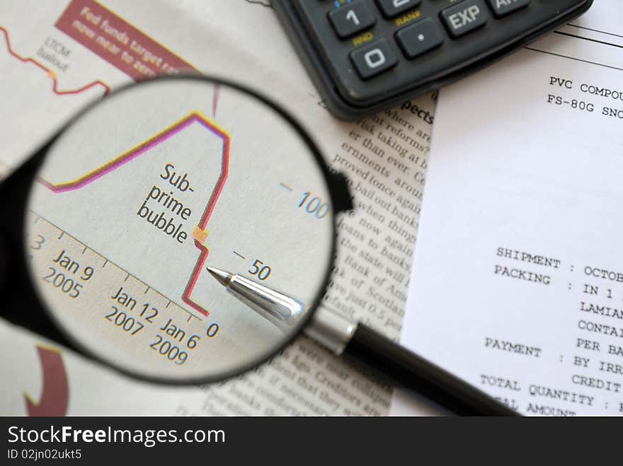 Magnification of falling financial graph of stock market, signifying business and finance, office life and stressful work life concepts.