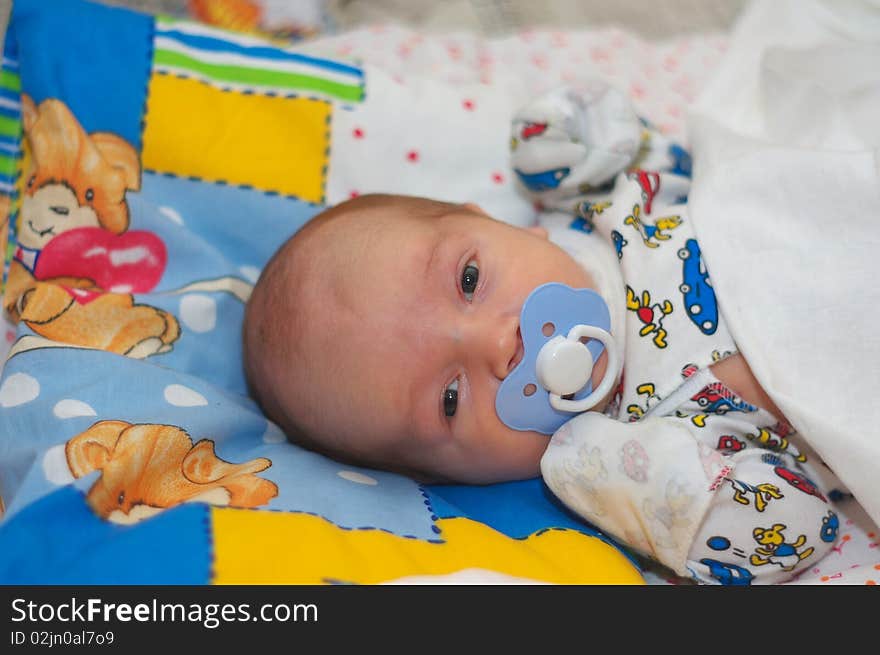 Photo of the beautiful baby lying on bed