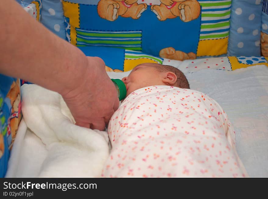 Photo of the beautiful baby lying on bed. Photo of the beautiful baby lying on bed