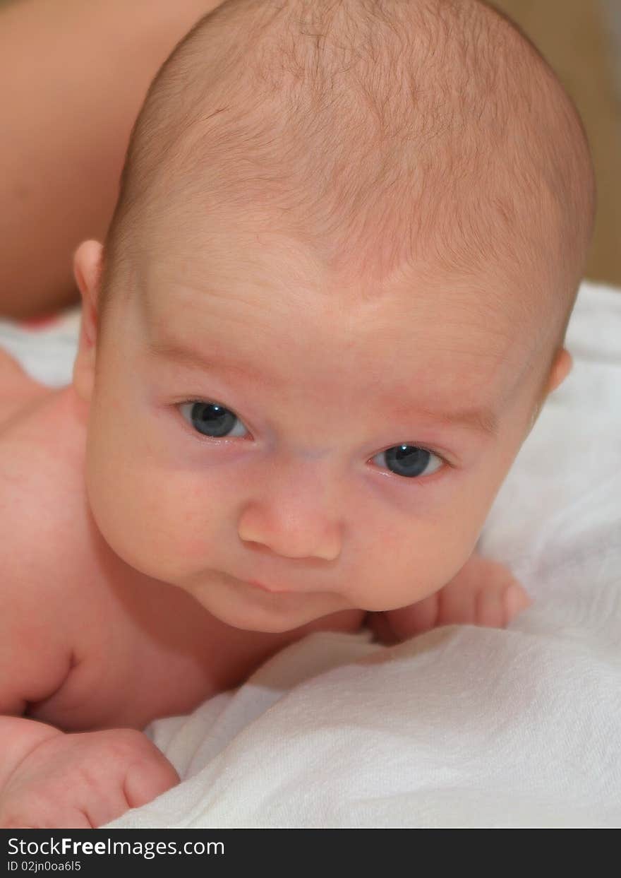 Photo of the beautiful baby lying on bed