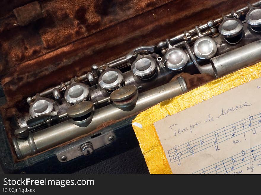 Silver like flute in his box near hand writen score