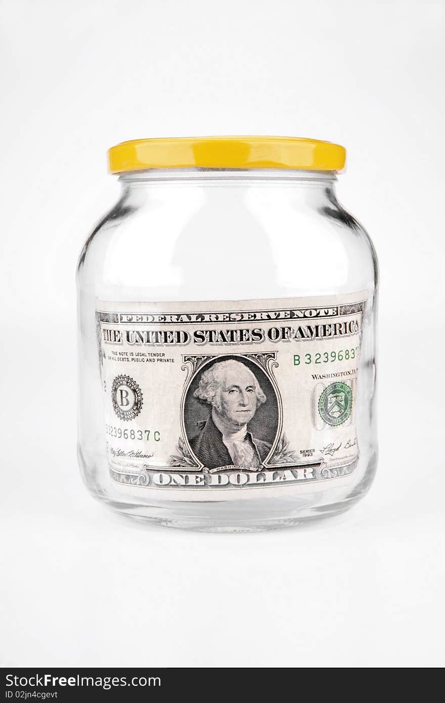 Dollar in a glass jar on a white background