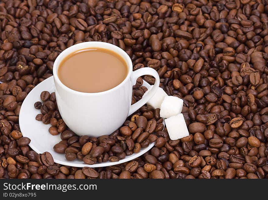 Cup of coffee at beans closeup