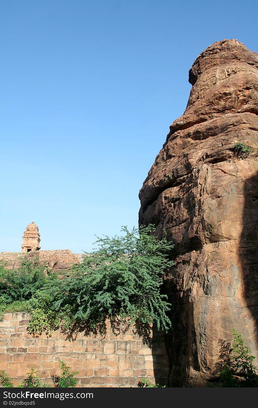 Tip of rock and temple tower on northern hill at Badami, Karnataka, India, Asia. Tip of rock and temple tower on northern hill at Badami, Karnataka, India, Asia