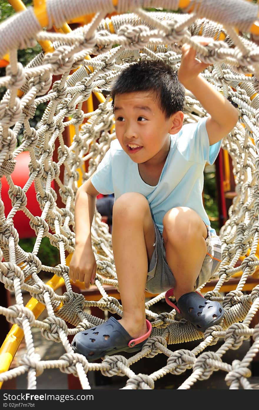 A child climbing a jungle gym.in playground