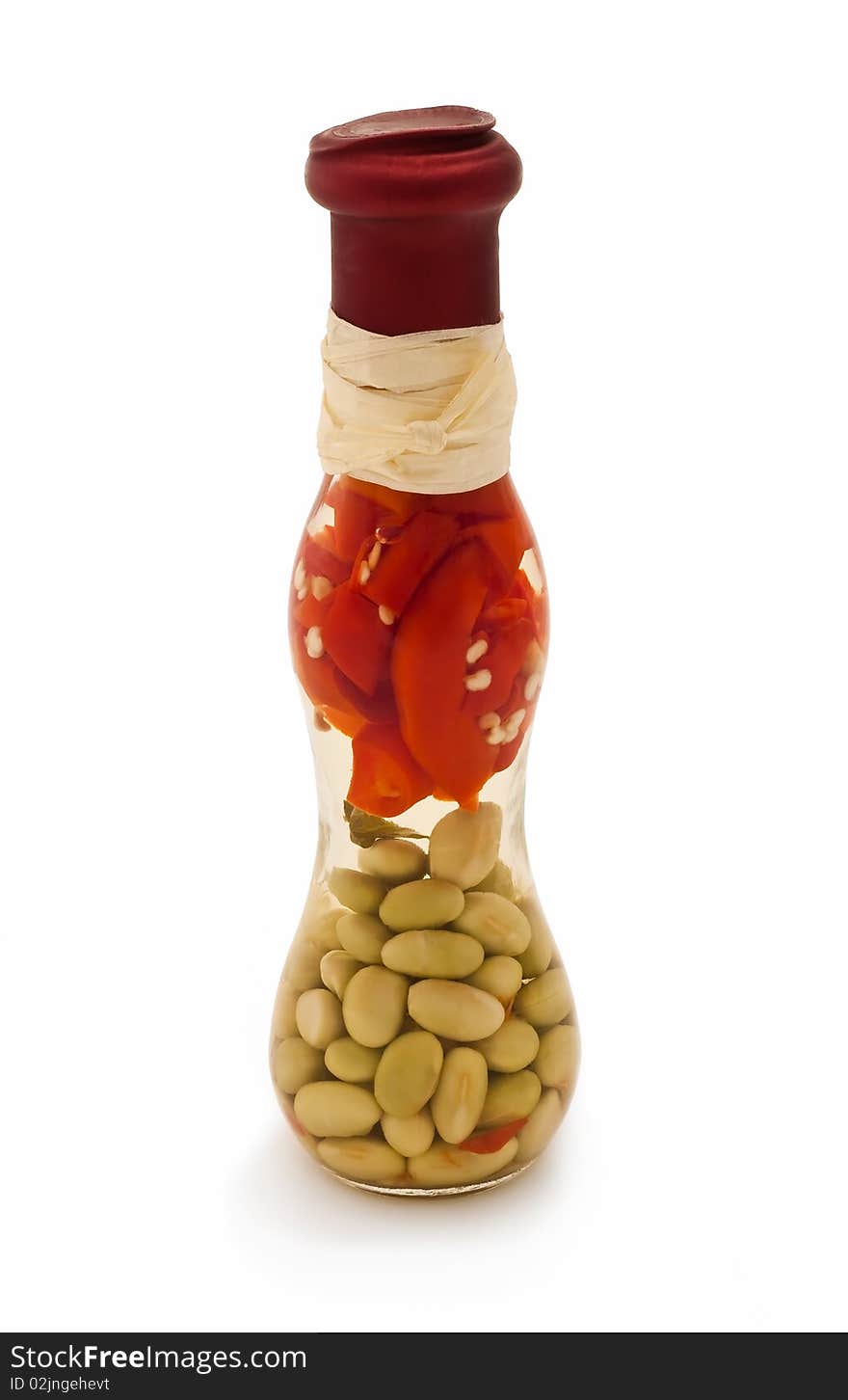 Decorative glass bottle with some red peppers and green beans