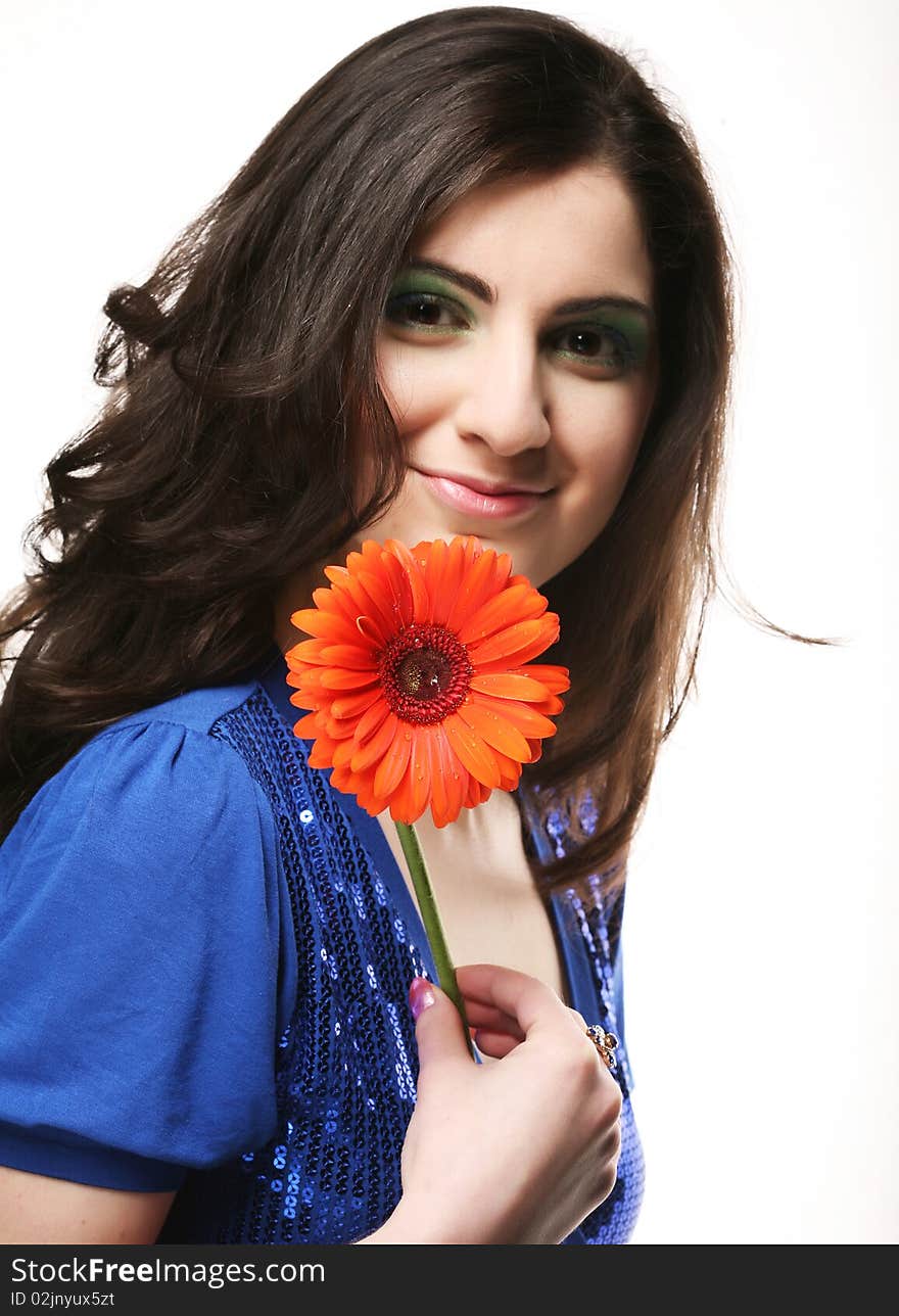 Beautiful young woman with gerber flower