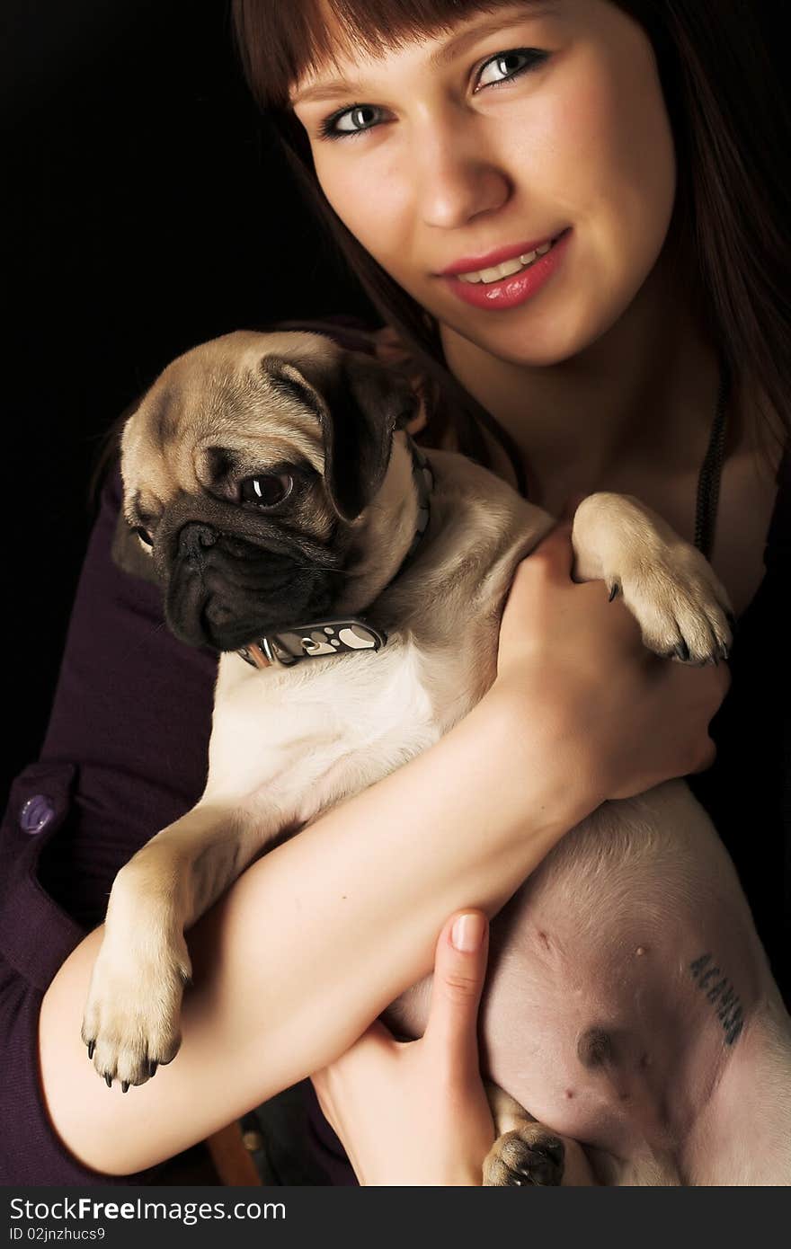 Girl and pug, studio shot