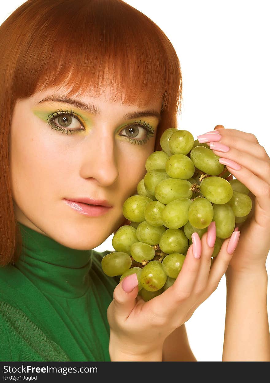 Close-up portrait of young attractive red woman with bunch of grapes. Close-up portrait of young attractive red woman with bunch of grapes