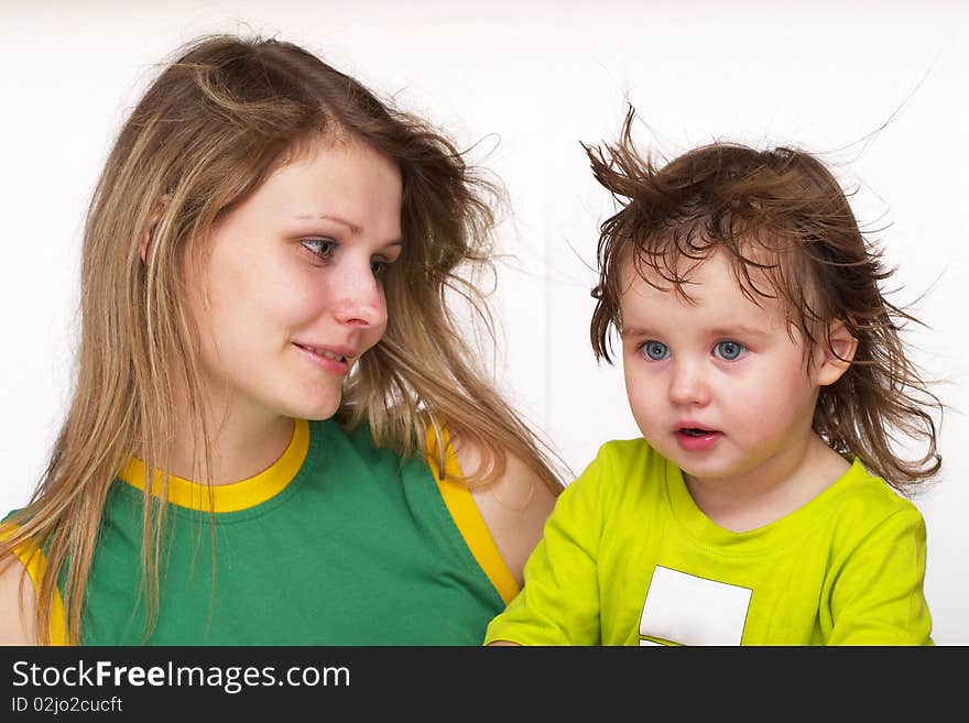 Young mother and her little daughter watching something. Young mother and her little daughter watching something