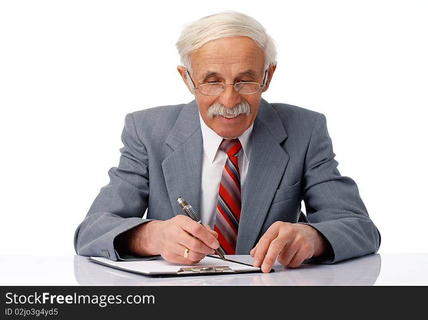 Portrait of an elder businessman writing something in the document over white. Portrait of an elder businessman writing something in the document over white.