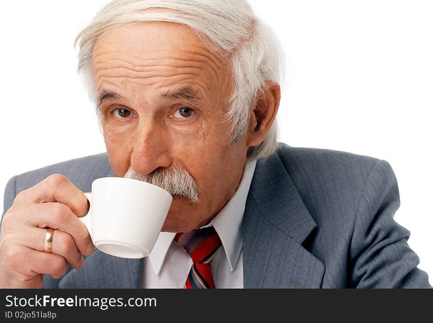 Portrait of an elder businessman drinking coffee over white. Portrait of an elder businessman drinking coffee over white.