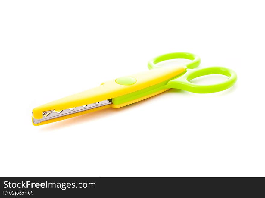 Green and yellow scissors isolated on white