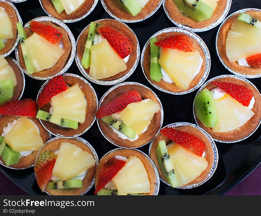 Many fruit tarts as dessert in a buffet restaurant