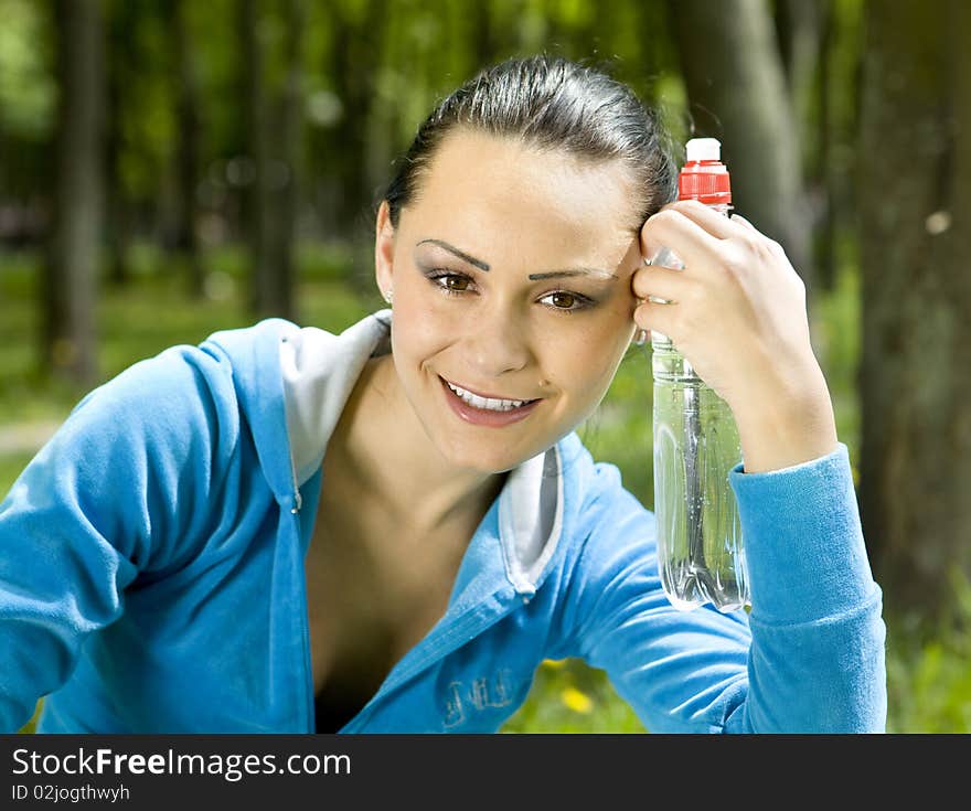 Portrait of woman smiling with bottle of water. Portrait of woman smiling with bottle of water