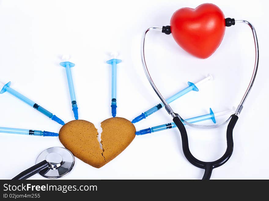 Healing a broken heart with blue syringe and a stethoscope