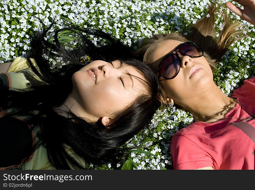 Two girsl lying on grass. Two girsl lying on grass