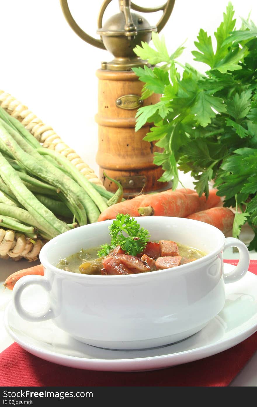 Green bean stew in a white soup cup