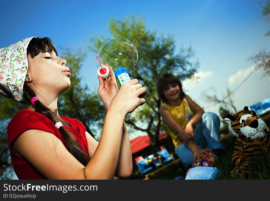 Girl in hat with soap bubbles