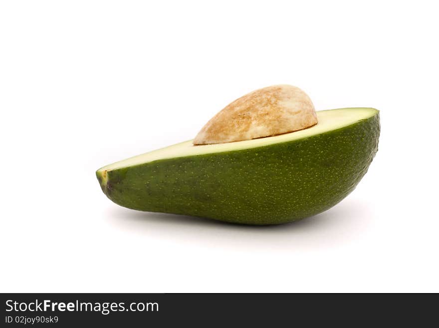 Half an avocado with stone isolated on white